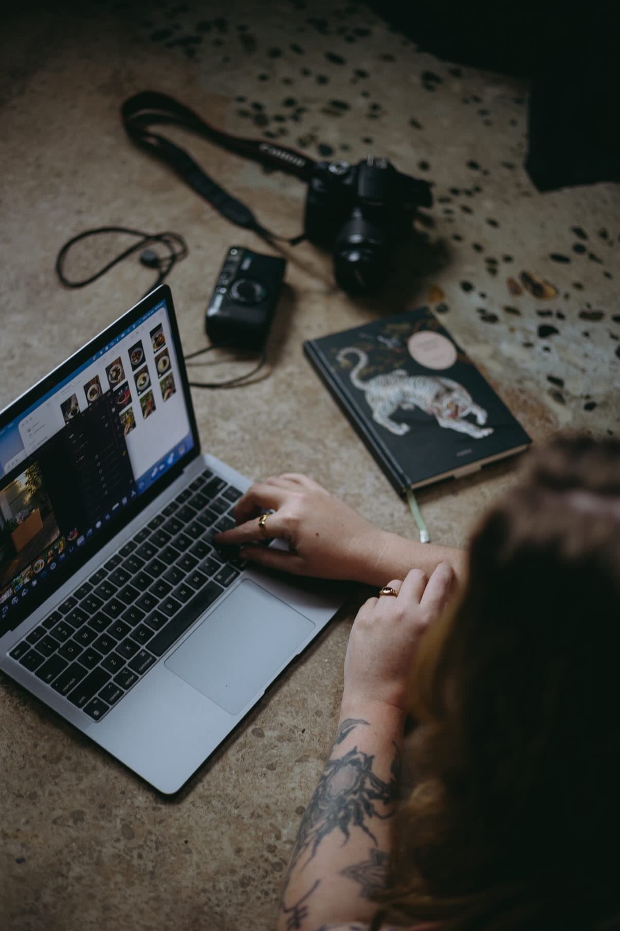 Over the shoulder, editing a month of content on the laptop