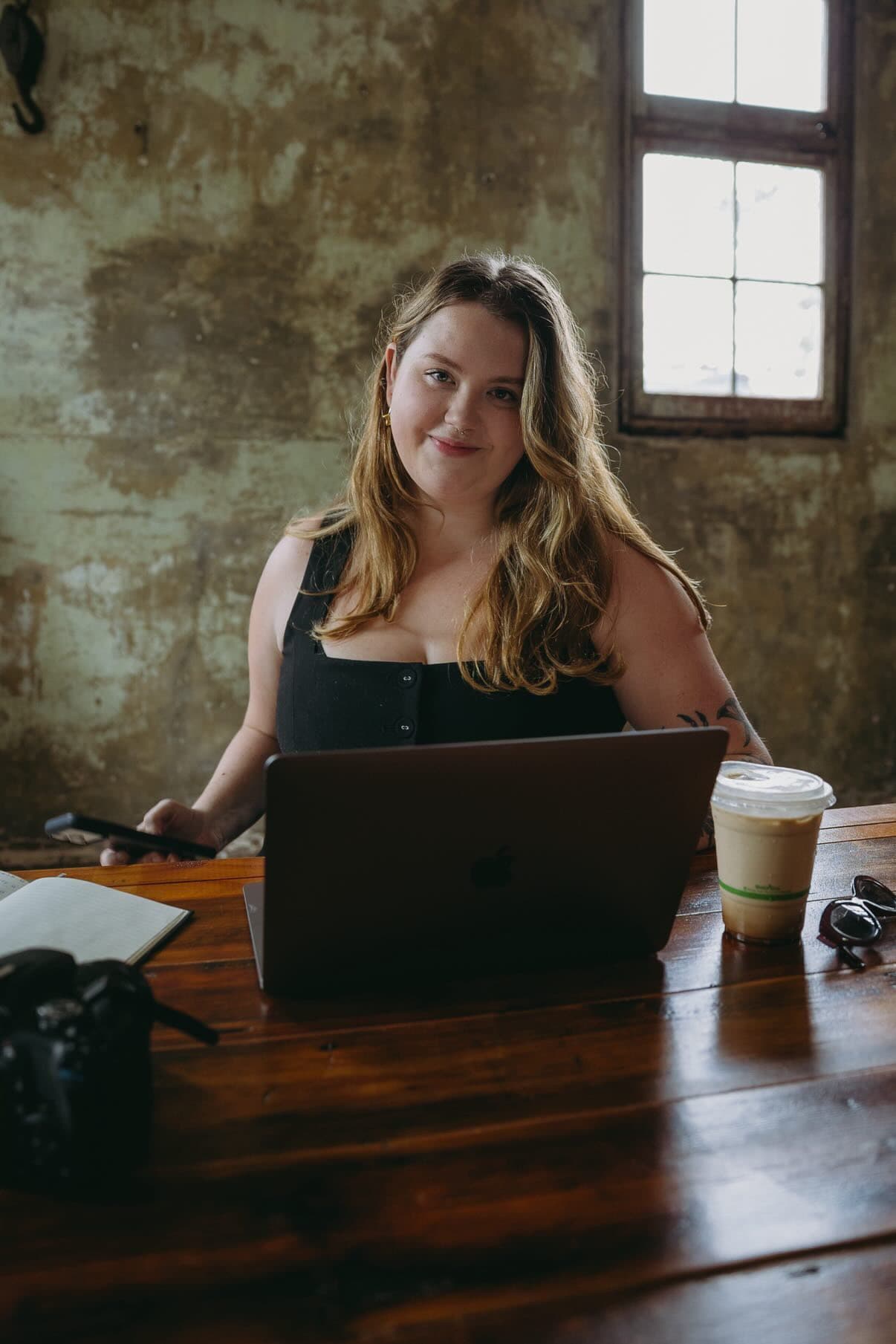Georgia Wylie, founder of Good Work Social, at her laptop